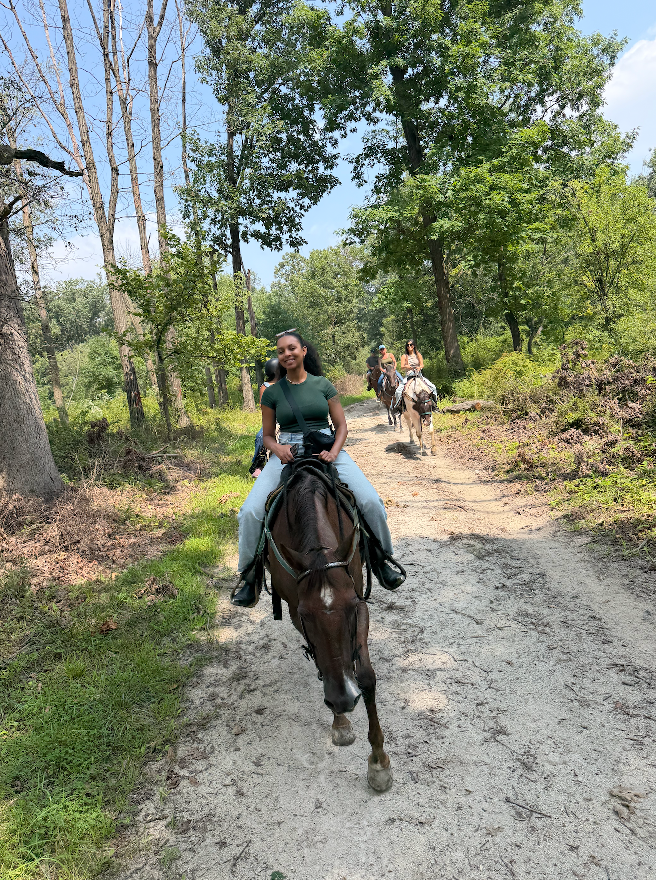 Women riding together on a wooded trail